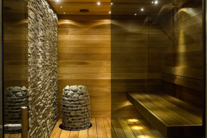 Relaxing sauna with intricately designed brick and wooden walls