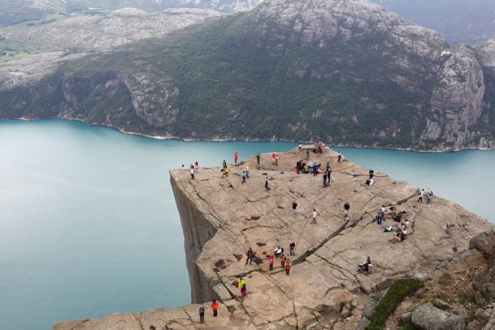 Hikers reach the summit of Pulpit Rock in Norway