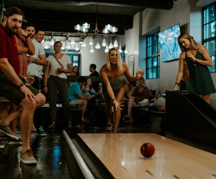 Group of people using a bowling lane
