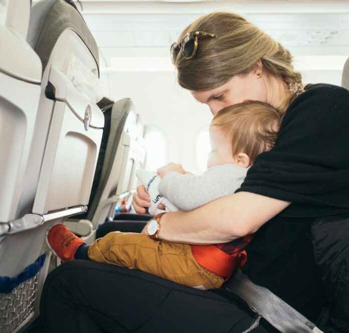 Baby on mother's lap on a commercial airplane