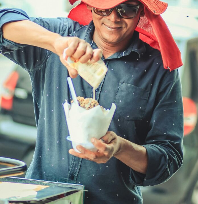 Street food vendor preparing a cup