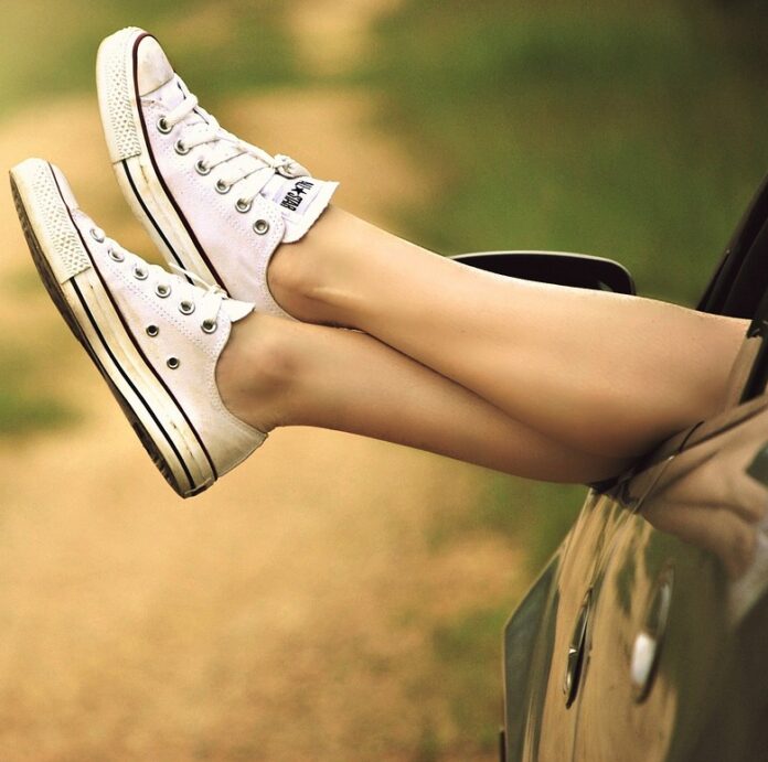 Woman's feet hanging out of car window