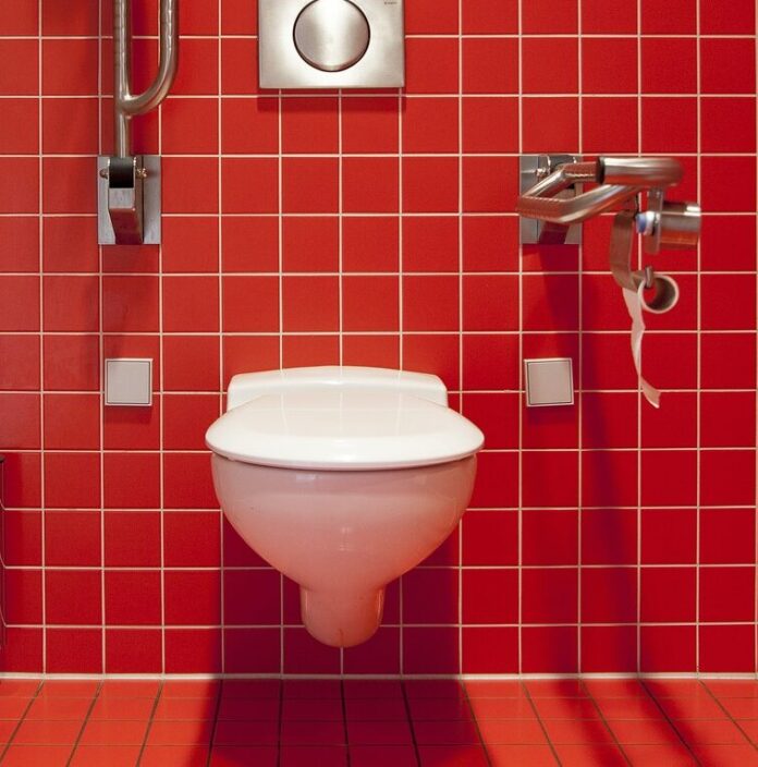 Toilet in a red-tiled bathroom