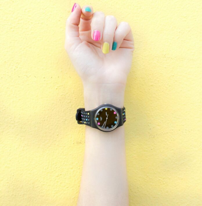 Hand with painted nails and a watch