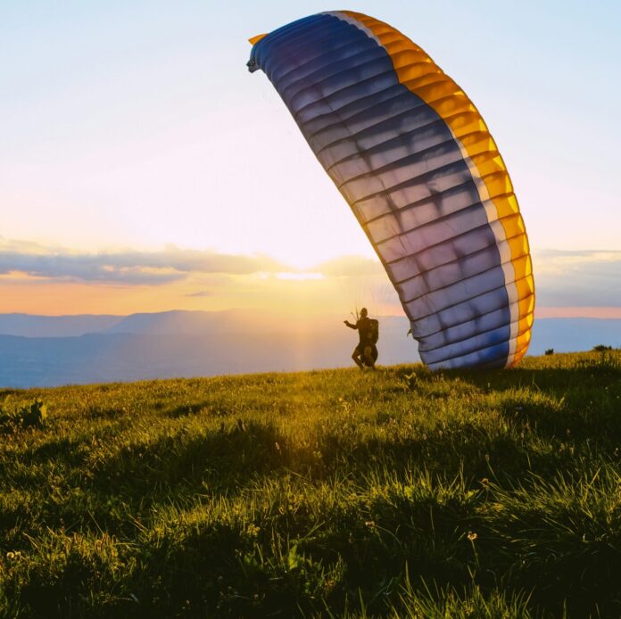 Paraglider landing on a hill