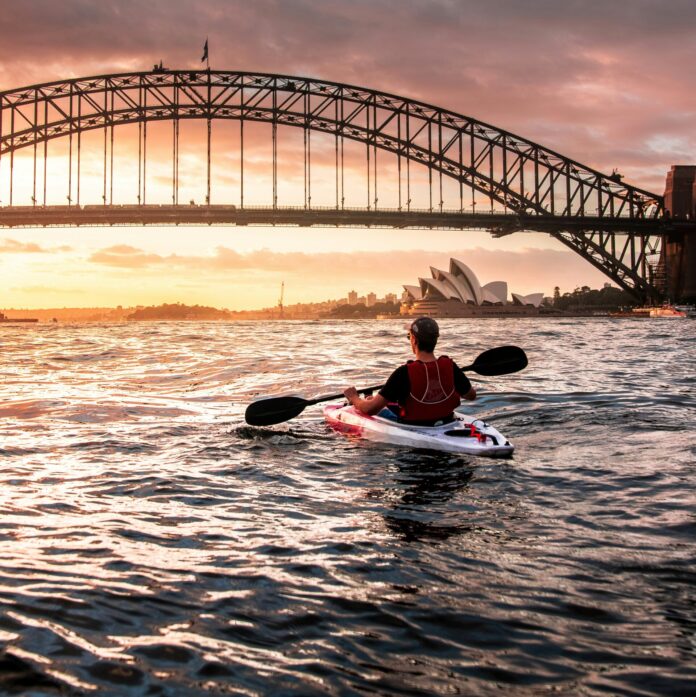 Kayaking under harbour bridge, Sydney, Australia