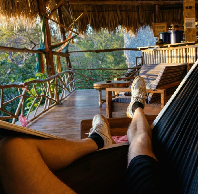 Guy with white shoes lounging in a Camping Hammock in Nicaragua