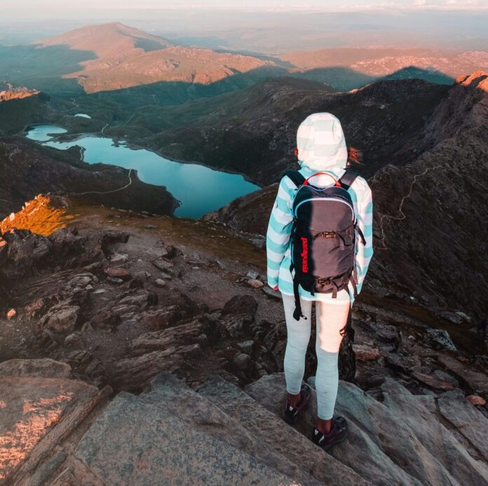 Woman admiring the view from Snowdon during sunset