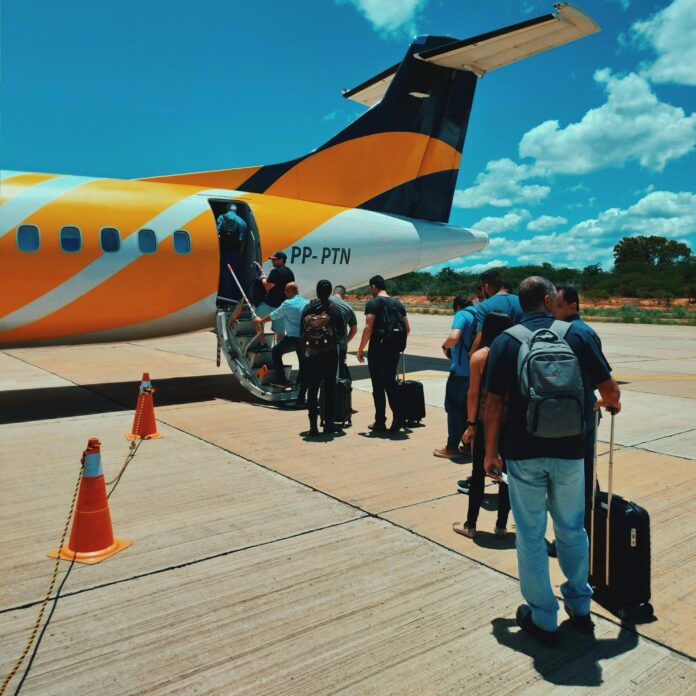 Group of tourists in queue before boarding