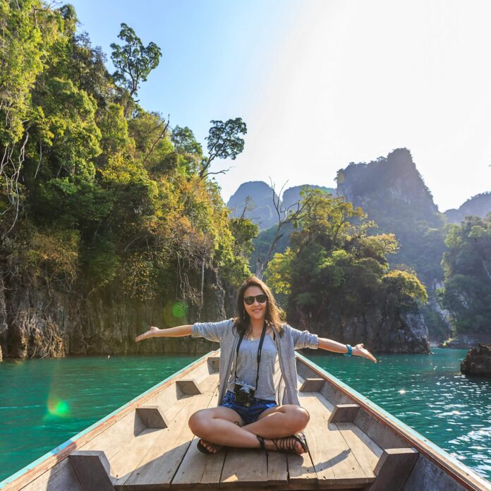 Photo of Woman Sitting on Boat Spreading Her Arms